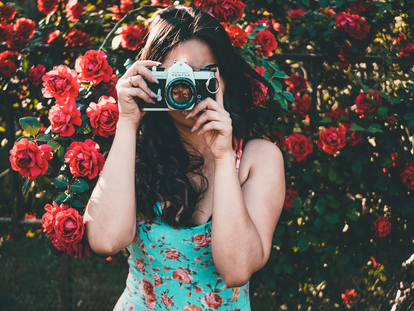 woman holding silver and black MILC-camera